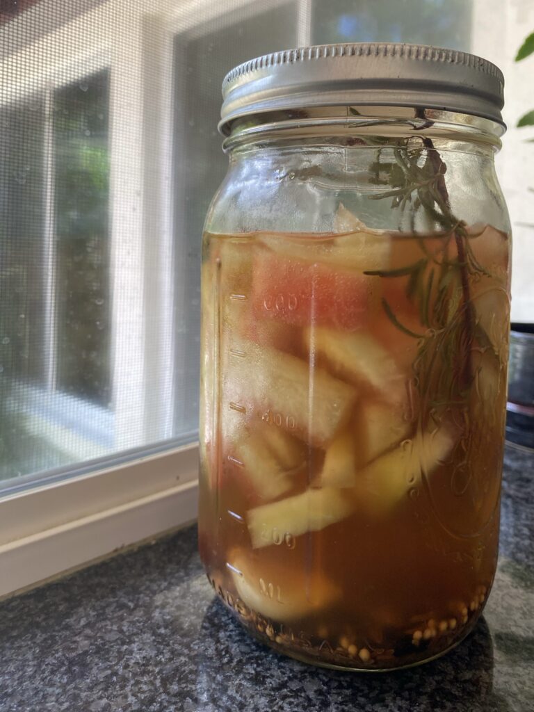 Pickled watermelon rind in mason jar on window sill